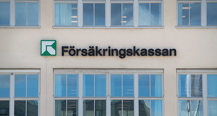 Fasaden på ett vitt hus med fönster. På fasaden finns Försäkringskassans logga.